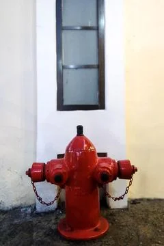 Classic Red Outdoor Fire Hydrant Against White Building Wall Stock Photos