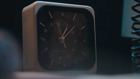 A classic retro alarm clock captured in a dramatic dim light 動画素材 327387633