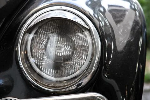 Classic round headlight of an old timer car, front view. Close up Stock Photos