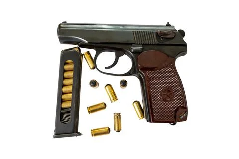 Classic semi automatic pistol with loaded magazine and loose ammunition car.. Fotos Stock