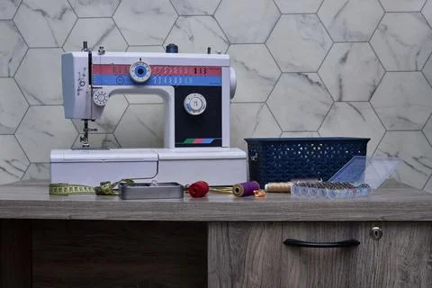 Classic Sewing Desk With Machine, Spools, and Measuring Tape In Craft Room Stock Photos
