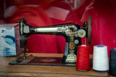 A classic sewing machine with red and white spools ready for the craft. Stock Photos