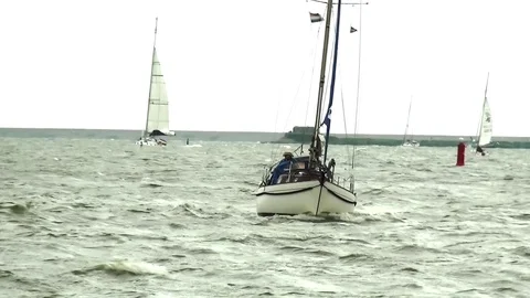 Classic sharp yacht comming to the port Stock Footage 94982087