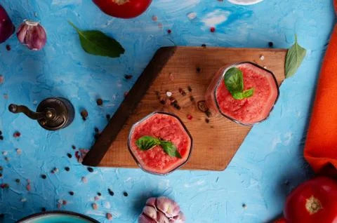 Classic spanish raw eating cold soup Gazpacho served  in glasses around blue  Stock Photos