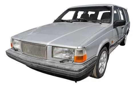 Classic station wagon on white background, showcasing sleek design, muted g.. Stock Photos