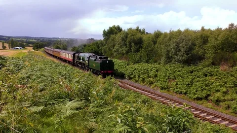 Classic steam train entering railway tunnel countryside track Stock Footage 80289709