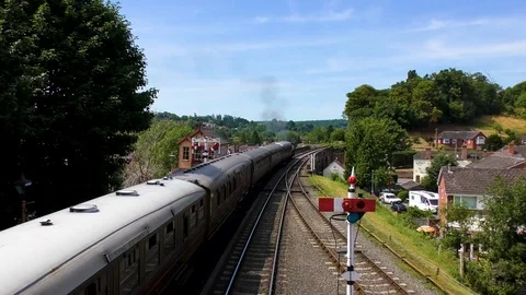 Classic steam train producing smoke travelling through countryside Stock Footage 80286418