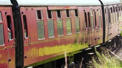 Classic steam train producing smoke travelling through countryside Stock Footage 80289196