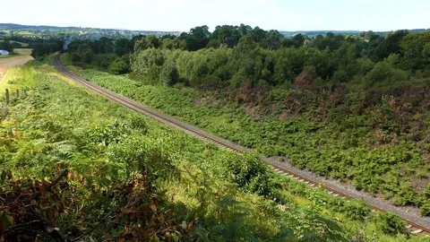 Classic steam train producing smoke travelling through countryside Stock Footage 80305870