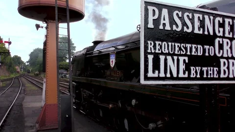 Classic steam train producing smoke country railway station Stock Footage 80314362
