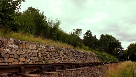 Classic steam train producing smoke travelling through countryside Stock Footage 80320341