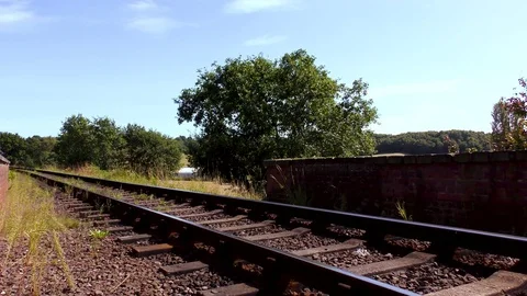 Classic steam train producing smoke travelling through countryside Stock Footage 80332567