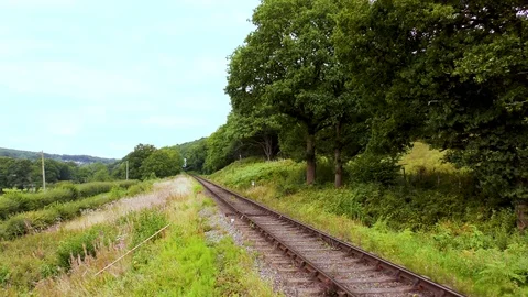 Classic steam train producing smoke travelling through countryside Stock Footage 80332976