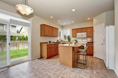 Classic style kitchen interior with tile flooring, white appliances, Stock Photos
