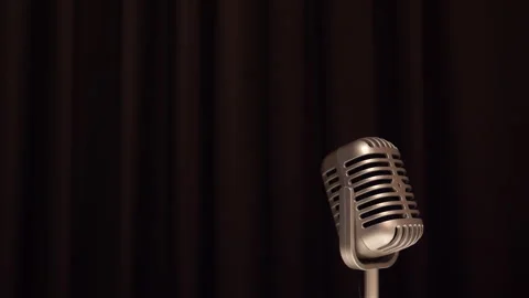 Classic style microphone rotating against dark stage curtain Vídeos de archivo 240137225