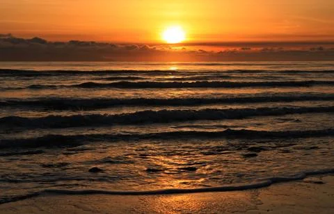 Classic sunset at the beach. Stock Photos
