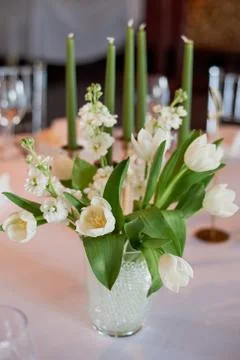 Classic table setting. White tablecloth.Vase with hydrogel and white flowers Stock Photos