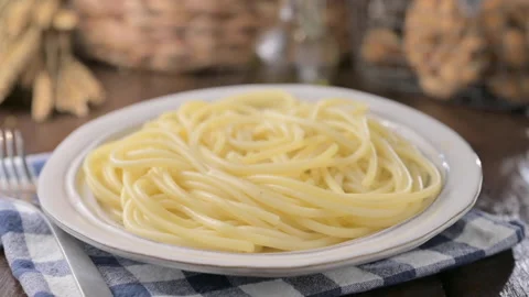 Classic thin, long pasta without sauce in a plate with hot steam. Traditional Video stock 205597178