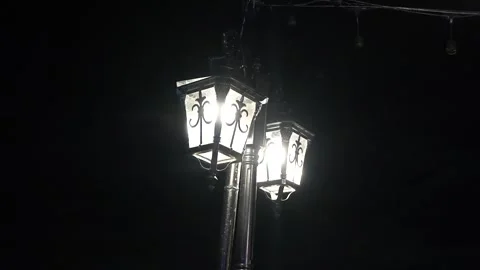 Classic Three-Lantern Street Lamp Illuminating the Night Stock Footage 321361622