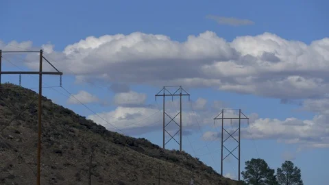 Classic time-lapse image of clouds and blue desert sky over electrical wires. Stock Footage 126927204