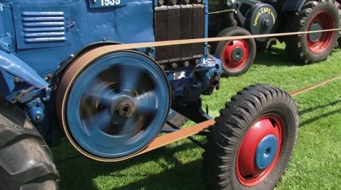 Classic tractor in use to power a threshing machine Stock Footage 62232300