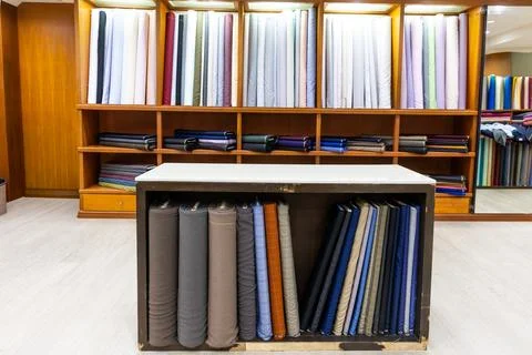 Classic traditional generic bespoke tailoring shop interior with cutting table Stock Photos