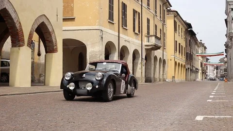 Classic triumph black car in typical Italian city Stock Footage 90135342