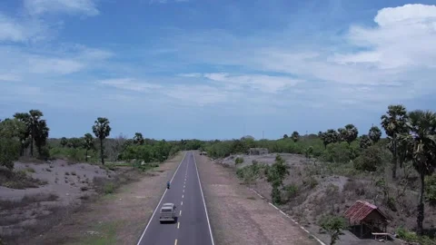 A classic van drives on a quiet road with a beautiful landscape. Stock Footage 310346659