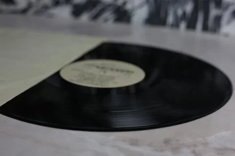 Classic vinyl record with packaging closeup on a light background Stock Photos