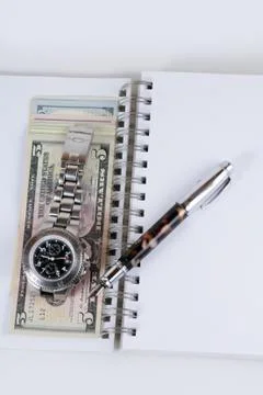 Classic Watch with a dollar, model on dollar banknotes and pen, notebook. Stock Photos