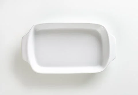 Classic white ceramic baking dish with handles Stock Photos