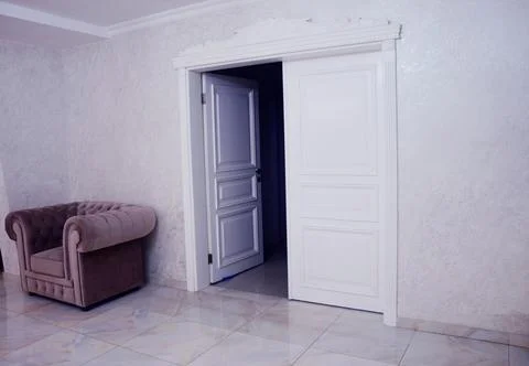 Classic white interior double doors with decorative cornice in a modern hallw 写真素材