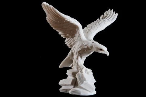 Classic white statuette of eagle isolated on black background Stock Photos