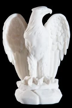 Classic white statuette of eagle isolated on black background Фото