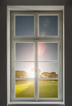 Classic white window and the forest view outside with sunset Stock Photos