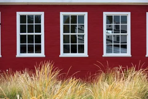 Classic white windows against red cedar siding Stock Photos