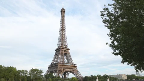 A classic wide angle view of the majestic Eiffel Tower rising into a soft cloudy Stock Footage 336363101