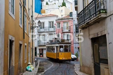 Classic yellow tram in alfama quater in lisbon, portugal Stock Photos