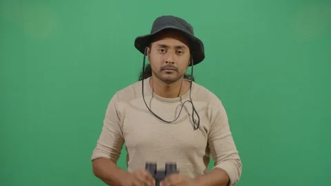 Classical adult man explorer chasing something in the frame with binoculars Stock Footage 117974597