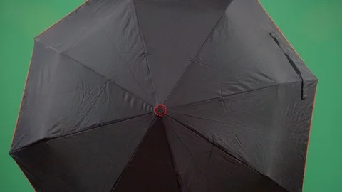 Classical adult man explorer opens an umbrella to reveal face studio isolated Vídeos de archivo 117974474
