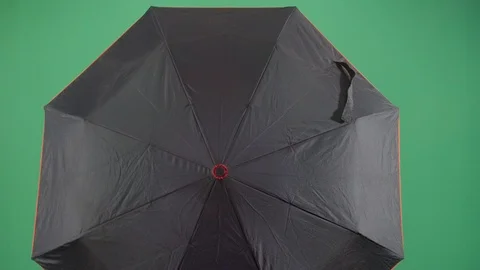 Classical adult man explorer opens an umbrella to reveal face studio isolated Vídeos de archivo 119662445