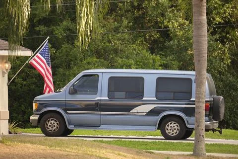 Classical americal van parked in front of a house. USA travel concept Stock Photos