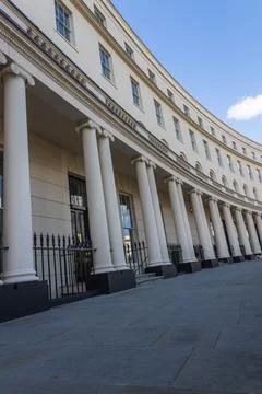 Classical architecture with white columns and stone facade Фото