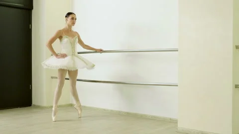 Classical ballet. Ballerina warming in pointe shoes in dance studio. 4K Video stock 88972693
