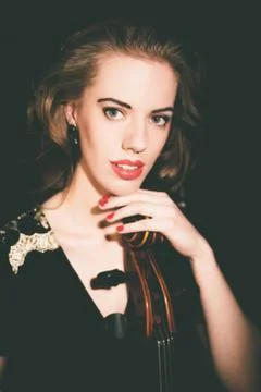 Classical beauty playing a classical instrument Foto stock