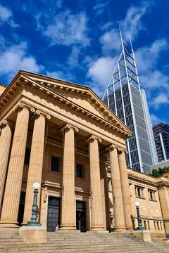 Classical building facade with modern skyscraper behind. Stock Photos
