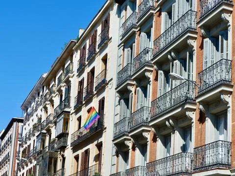 Classical buildings of different colours with chic windows and balconies do.. Stock Photos
