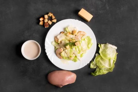 Classical Caesar salad with sliced chicken meat, cheese and fresh Stock Photos