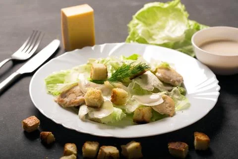 Classical Caesar salad with sliced chicken meat, cheese and fresh Stock Photos
