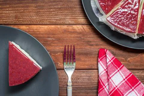 Classical cheesecake with raspberry jelly on rustic wood table background, to Stock Photos
